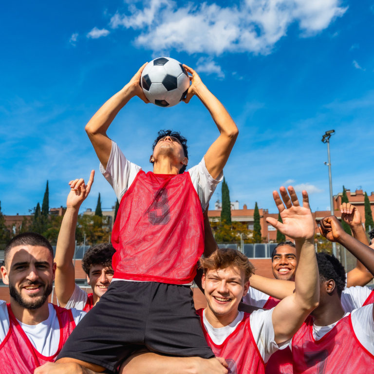 Creating inclusive football opportunities for autistic and neurodivergent young people Young people celebrating together during a football session, promoting inclusion, teamwork and belonging.