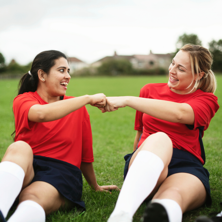 Young people celebrating together during a school sports session, highlighting inclusive participation and belonging for all learners.