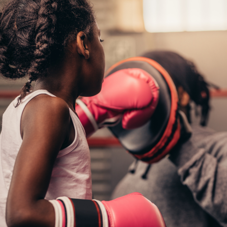 Building confidence through inclusive boxing and physical activity Young person learning boxing with a coach, building confidence, resilience and physical skills through inclusive sport.