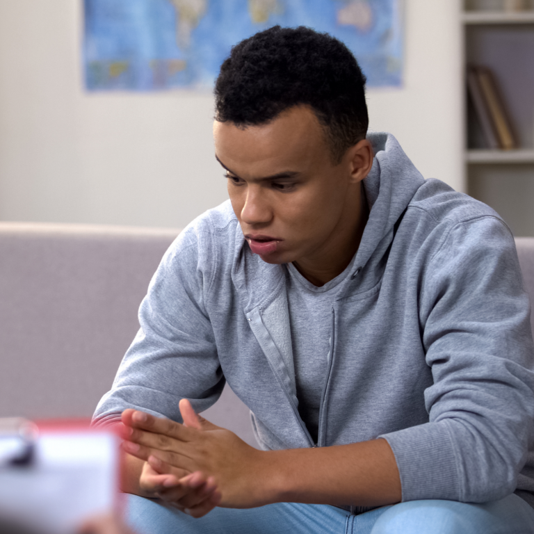 Young person experiencing anxiety, highlighting the need for inclusive educational support.