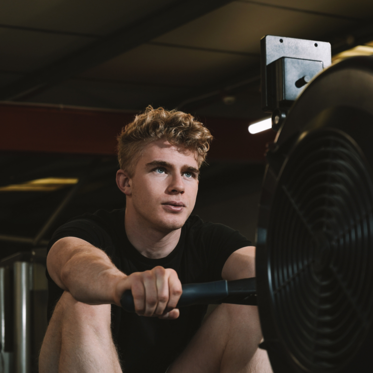 Young person using a rowing machine, building confidence, fitness and wellbeing through inclusive exercise.

